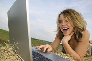 photo of girl using laptop computer